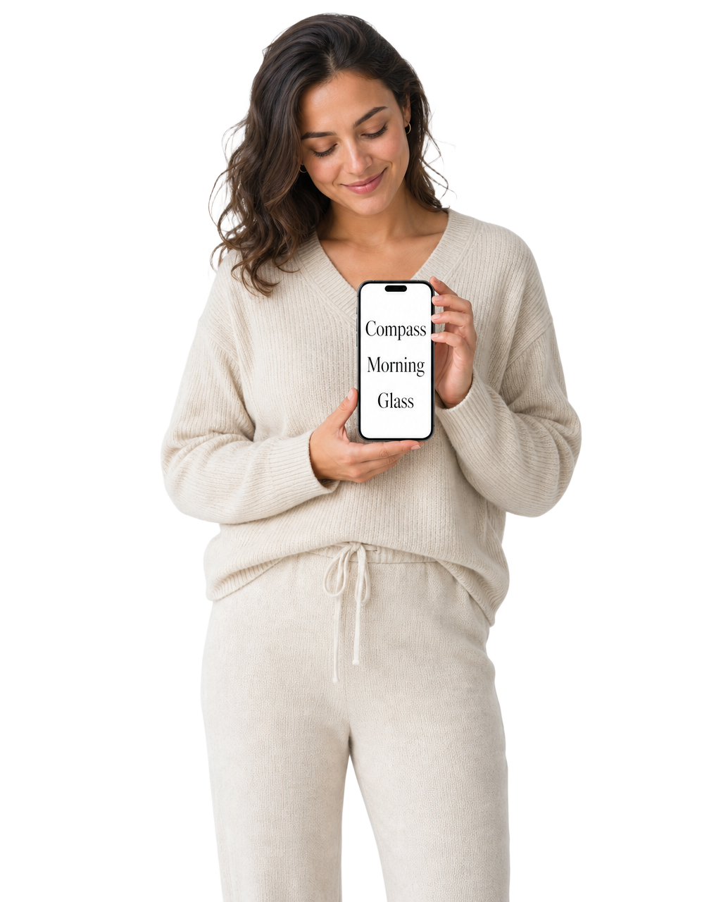 A woman smiling quietly at her phone, which reads Compass, Morning, Glass